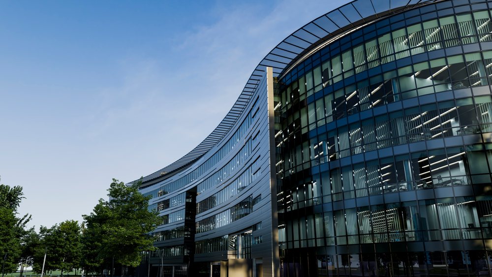 Modern curved office building with glass facade.