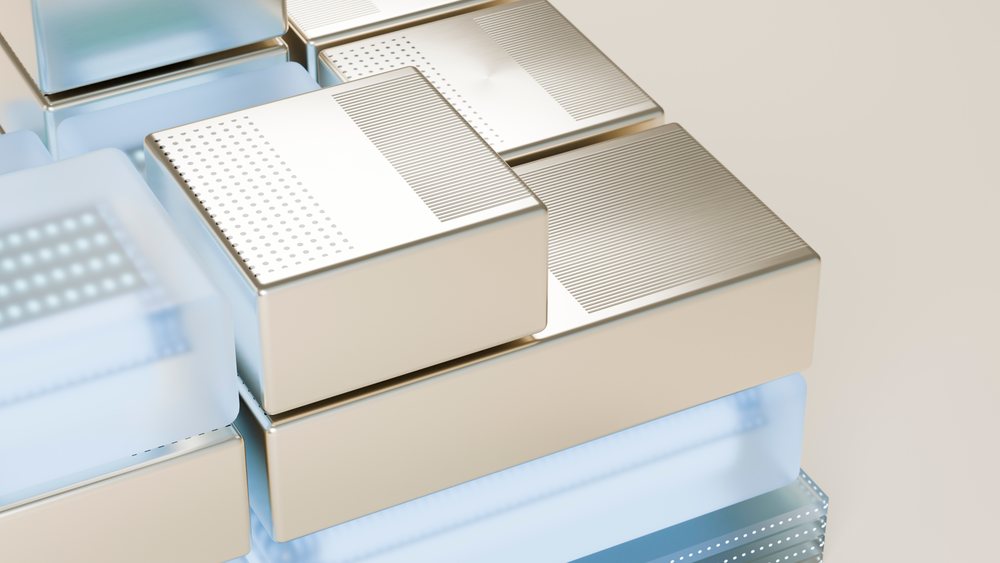 Close-up of stacked metallic and blue translucent rectangular blocks with dotted and lined textured surfaces in a modern abstract geometric design.