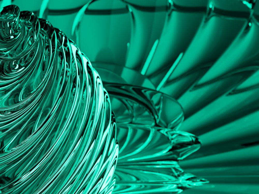 Close-up view of a decorative turquoise glass sculpture featuring swirling and twisted shapes forming abstract patterns.