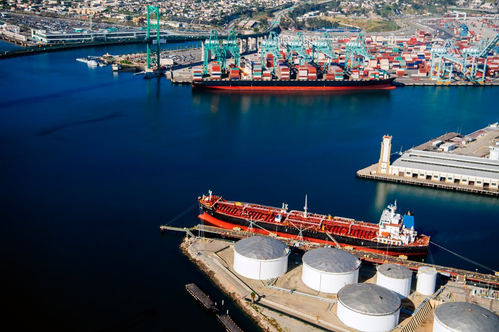 Container and oil tank ships docked at port terminals with storage tanks and cranes at the, Port of Long Beach, CA, USA.