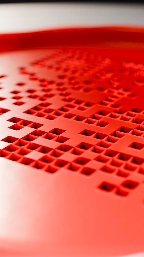 Close-up view of a red plastic surface.