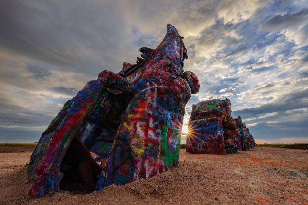 Graffiti-covered cars at Cadillac Ranch sculpture are, Storm Chasing, Amarillo, Texas, USA.