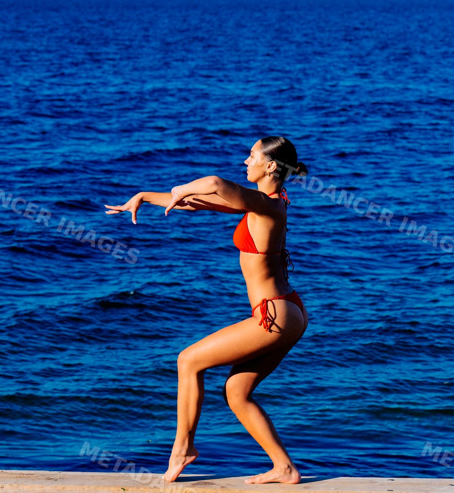 Young woman in swimwear standing near the ocean in wa USA