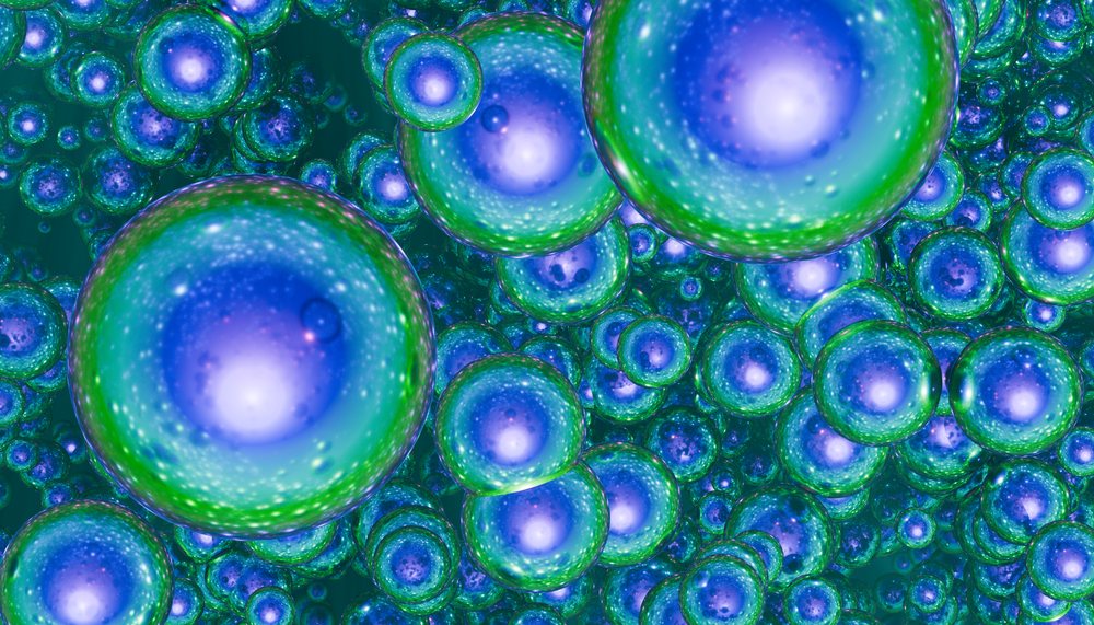 Blue and green glowing 3D spheres clustered closely together forming an abstract colorful pattern.