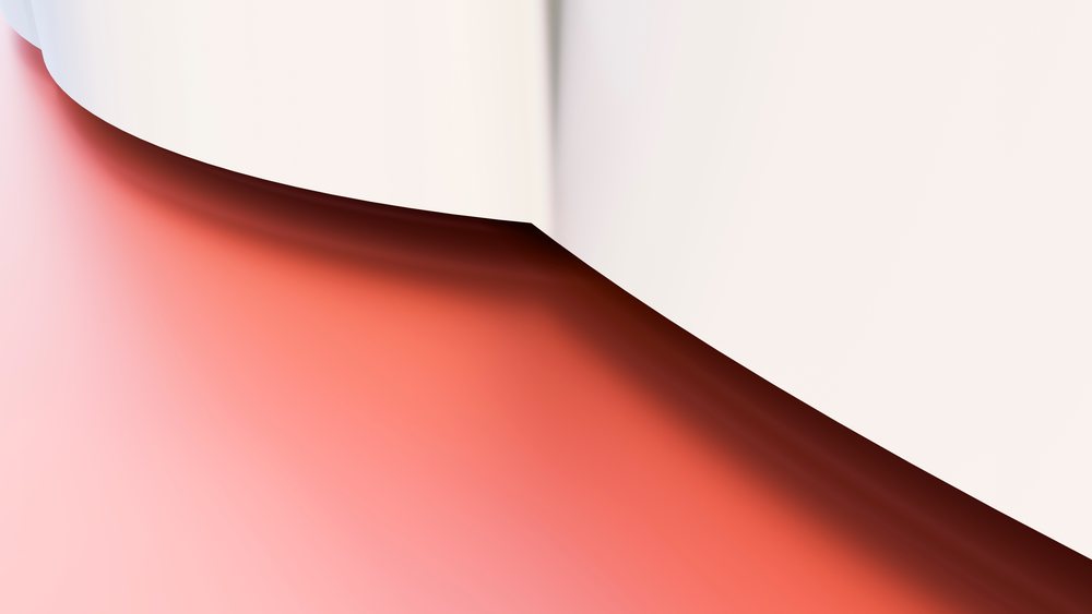 Curved white and peach paper creating an abstract minimal composition with shadows under studio lighting.