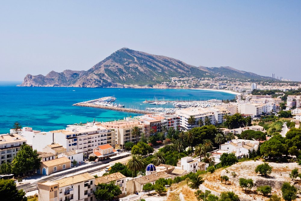 Marina harbor with boats and a mountain overlooking the Mediterranean Sea, Costa Blanca, Spain.