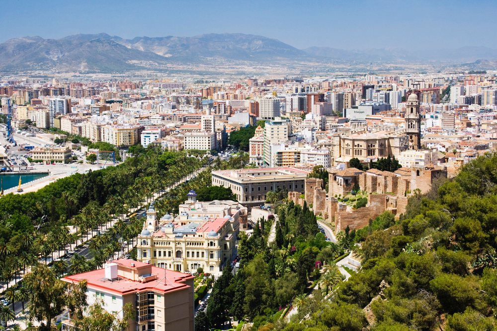 Malaga cityscape with historic architecture and mountains, Andalucia, Spain.