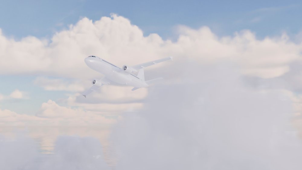 White airplane flying through blue sky with clouds.