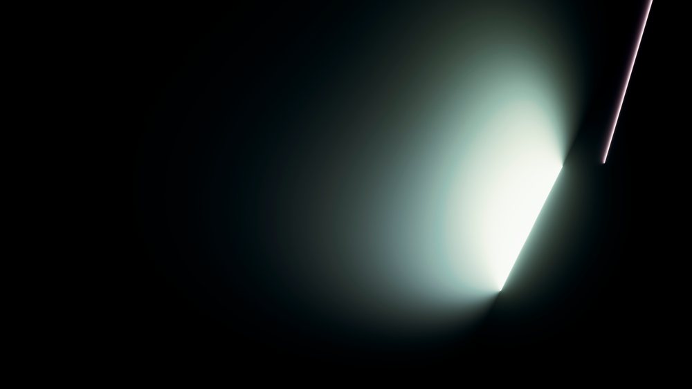 Visible bright light beam creates a radiant glow and strong contrast against a dark background.