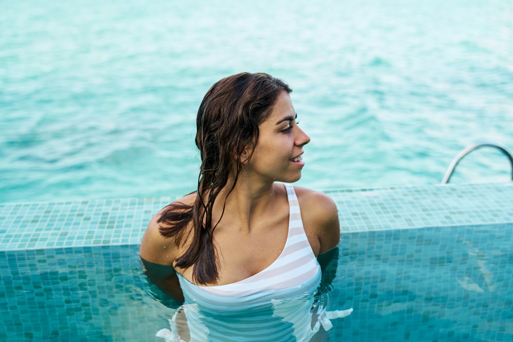 White Woman relaxing in a swimming pool