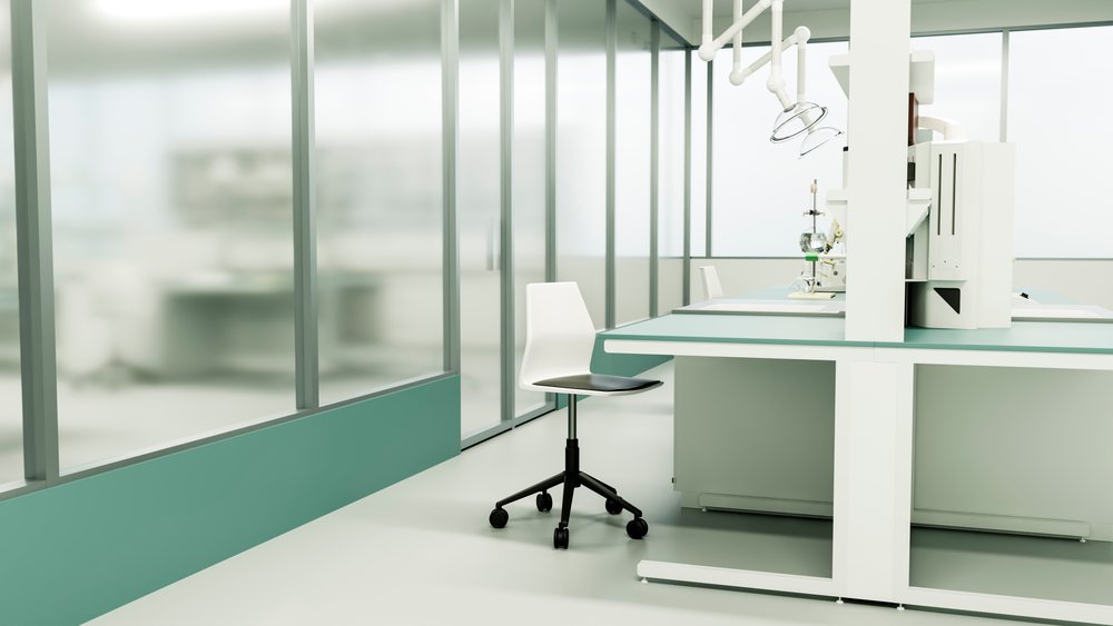 Laboratory workspace featuring a lab chair and scientific equipment arranged on a clean bench in a modern research facility.