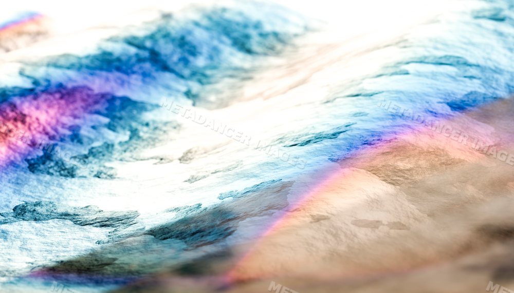 Close-up view of colorful light reflections on a water surface