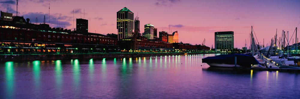 Puerto Madero waterfront with city skyline and boats at dawn, Puerto Madero at Dawn Buenos Aires, Argentina.