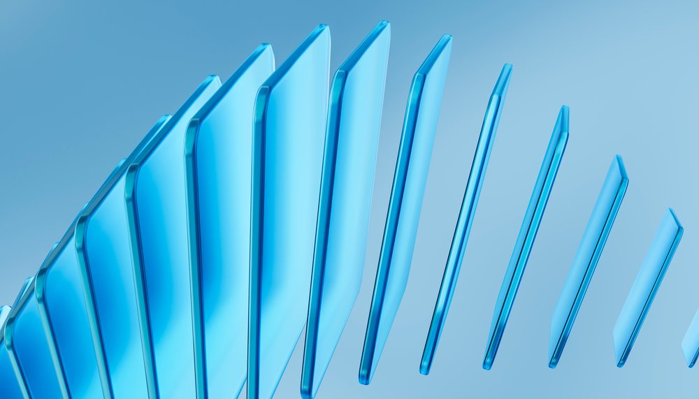 Blue transparent panes of glass arranged in a staggered abstract formation on a blue gradient background.