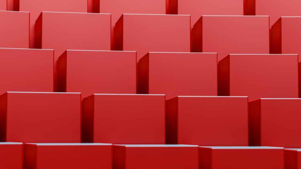 Stacked red rectangular blocks arranged in a repeating geometric abstract pattern with clean lines and layered structure.
