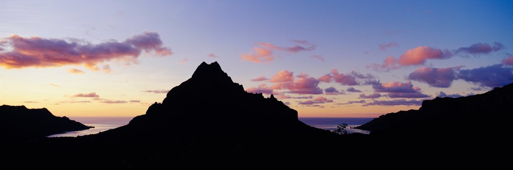 Silhouette of Mount Rotui at sunset on Moorea with colorful sky and ocean, Sunset Moorea, Polynesia.