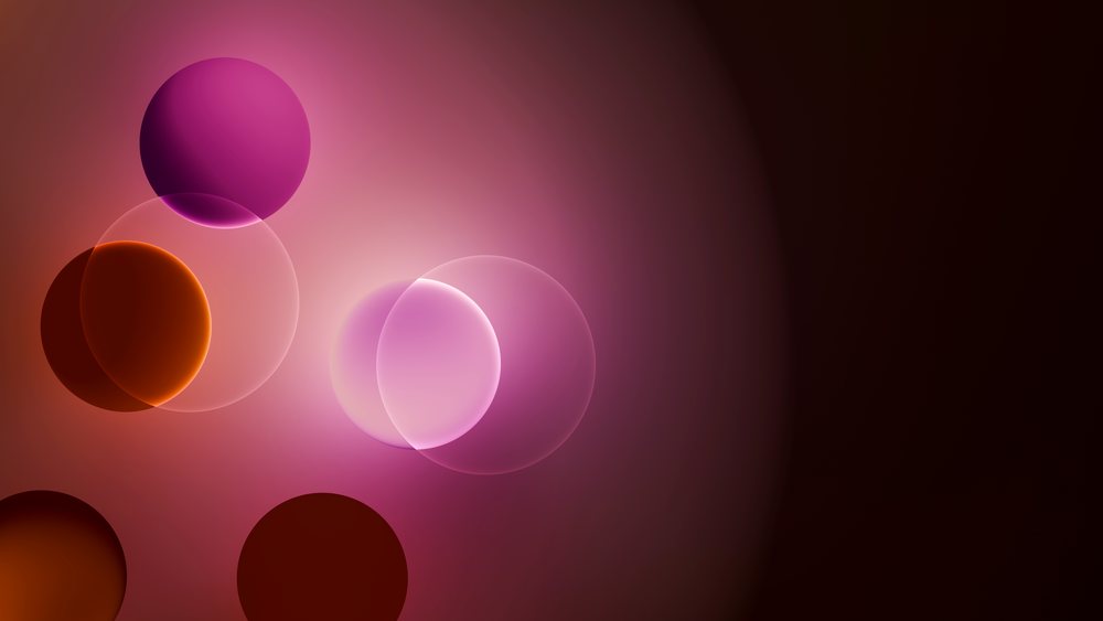 Abstract digital illustration depicting multiple overlapping translucent spheres in purple and orange on a dark gradient background.