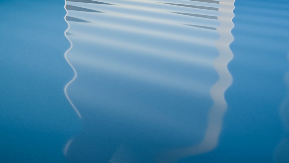 Water surface with gentle ripples reflecting light, creating a tranquil natural pattern.