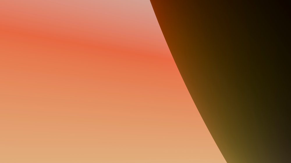 Sunset sky with a warm orange gradient and dark silhouette on the right side during evening twilight.