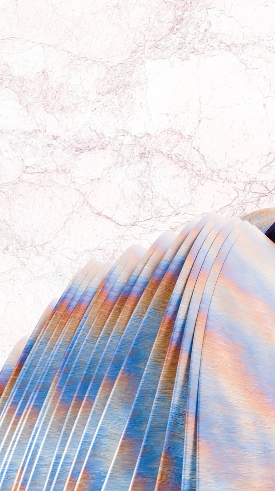 Curved stacked metal sheets featuring blue and orange hues with visible surface texture and signs of weathering.