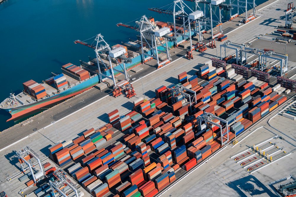 Container port with stacked shipping containers and cargo ship, Port of Long Beach, CA, USA.