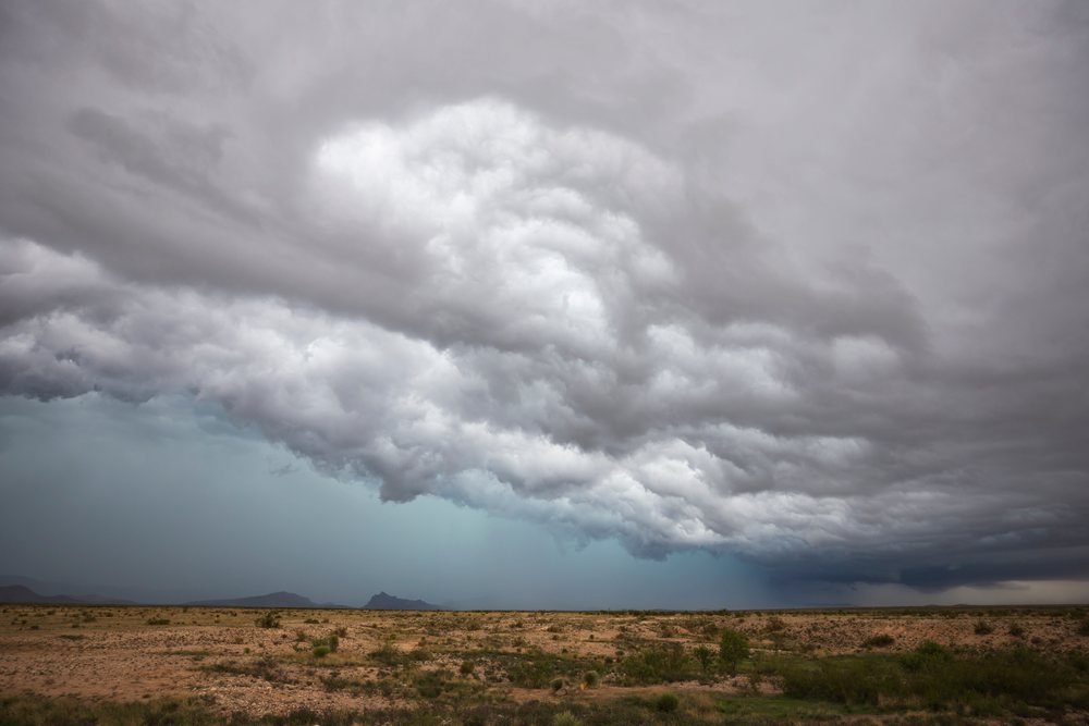 Supercell storm clouds produce heavy rain over an arid landscape in Tornado Alley, Great Plains, Marathon, Texas, USA.