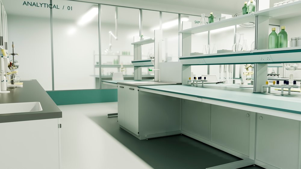 Modern clean laboratory interior showing scientific instruments, glassware, microscope, test tubes, and chemical bottles on benches and shelves for research.
