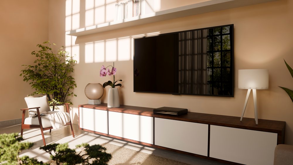 Modern living room features a mounted flat screen television above a wooden console, a white armchair near a large potted plant, and decorative lamps.