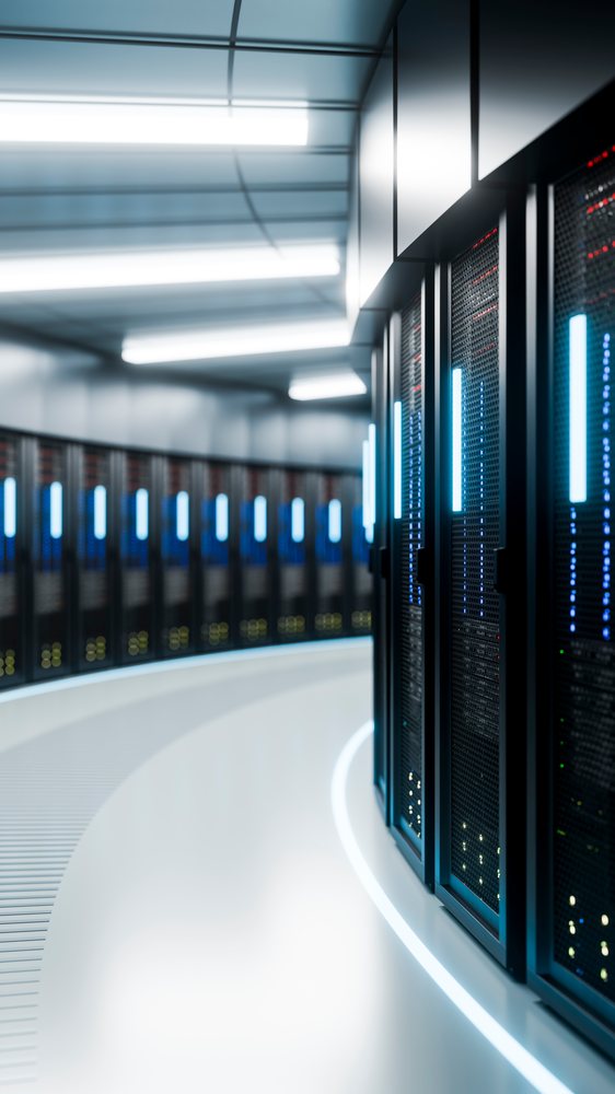 Rows of black server racks with illuminated panels inside a high-tech data center room.