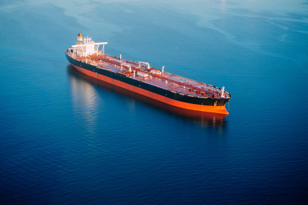 Oil tanker ship anchored in calm blue ocean water, Port of Long Beach, CA, USA.