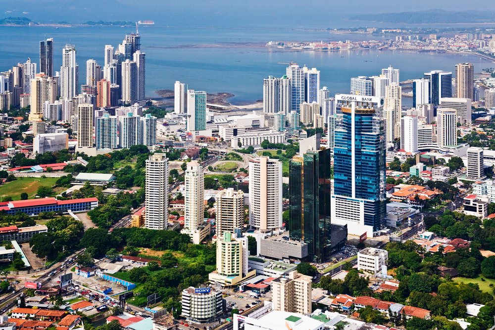 Panama City skyline with modern high-rise buildings along the coastal waterfront under daylight showing urban development and green areas.