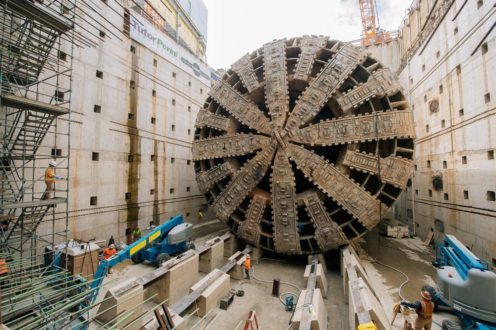 A large tunnel boring machine and construction workers are at an excavation site, a large tunnel boring machine, drilling, USA.