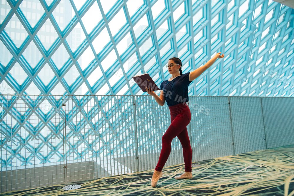 Woman practicing ballet and reading a book