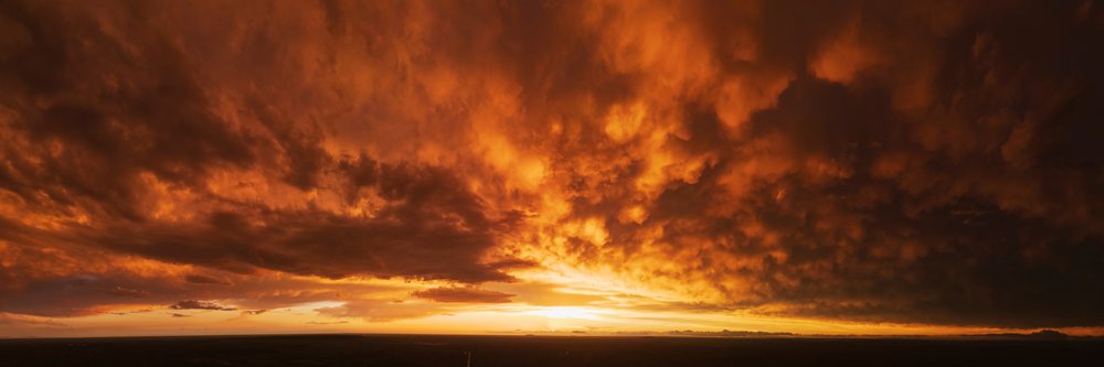 Sunset with dramatic storm clouds over the flat silhouetted landscape of, Storm Chasing, Weather, Environment, Uvalde, Texas, USA.