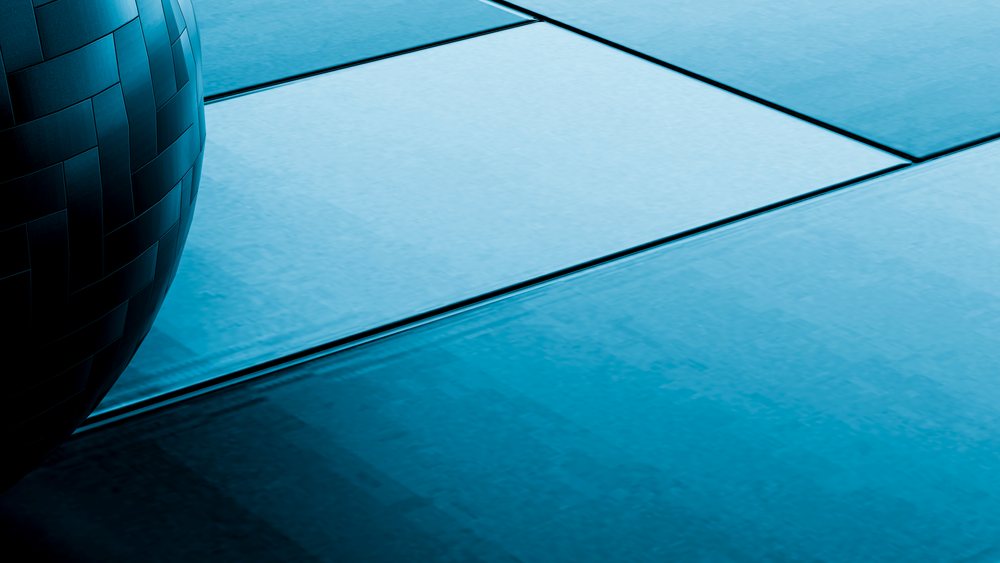 Blue ceramic floor tiles with a glossy geometric pattern in a modern indoor interior design setting.
