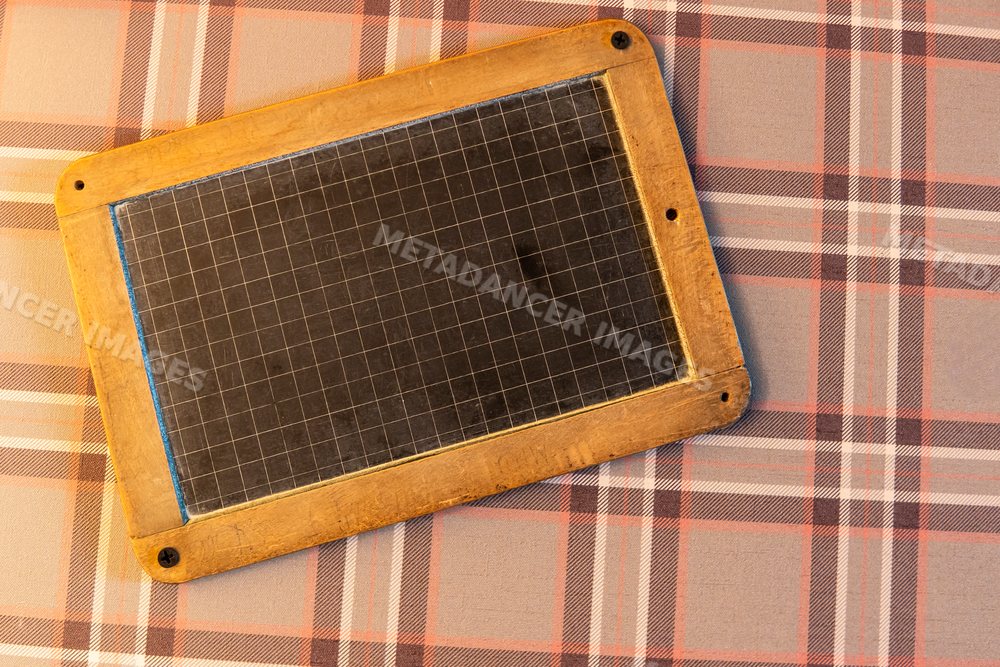 Vintage slate board with grid lines on plaid fabric in Verdun, France