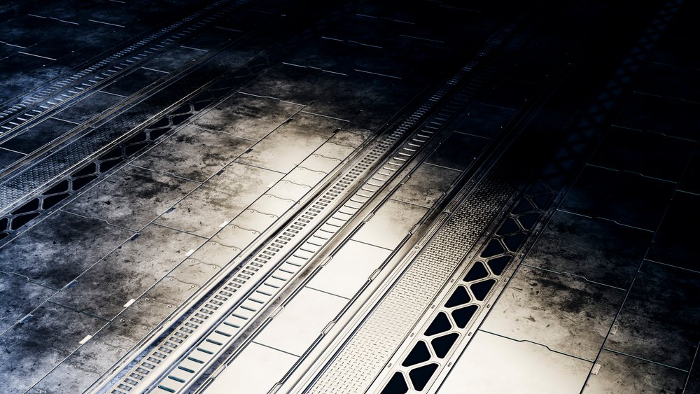 Metal industrial floor panels with grates and textured steel surface in a factory or mechanical setting.