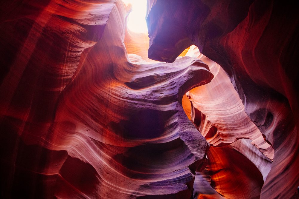 View of slot canyon sandstone rock formations with natural light, Navajo Land, Arizona, USA.