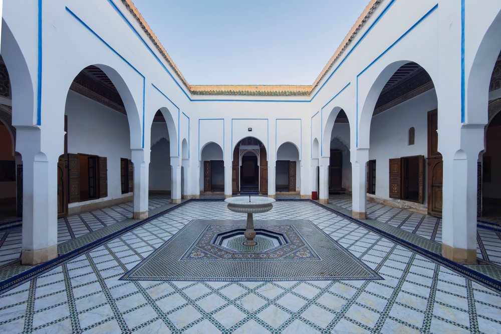 Courtyard with tiled floor and decorative fountain at Bahia Palace, Morocco under open sky, Lifestyle, Landscape, Culture, Marrakech, Marrakesh-Safi Region.