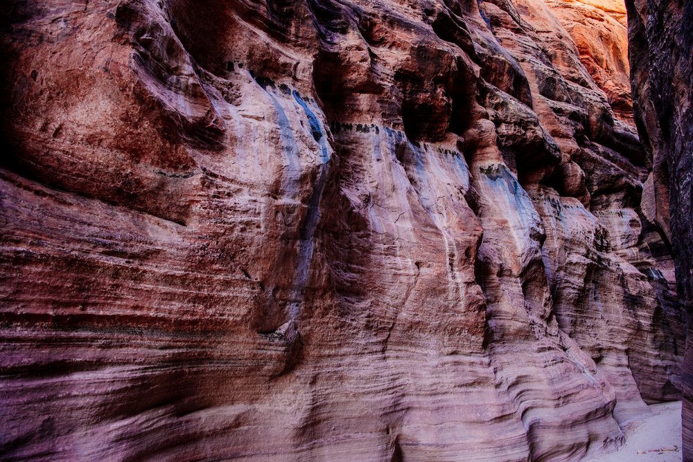 Slot canyon with narrow winding sedimentary sandstone walls and visible erosion along a path, Buckskin Gulch, Utah, USA.