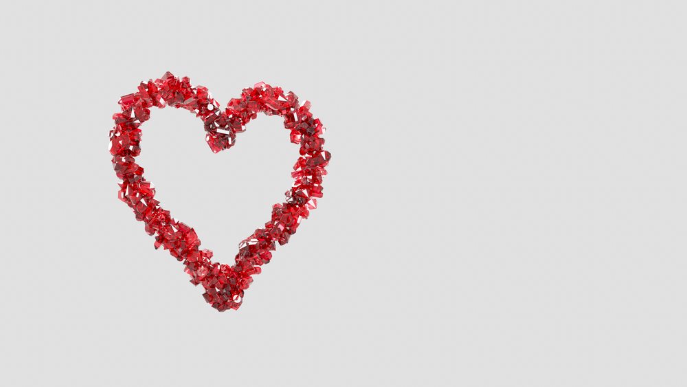 Red transparent crystals formed into a heart shape on a gray background in 3D digital art style.