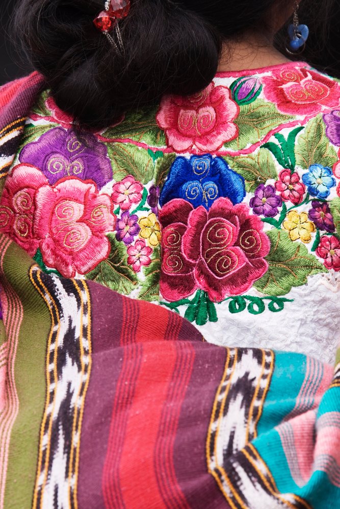 Woman wearing an embroidered blouse and a colorful shawl, Chichicastenango, Guatemala.