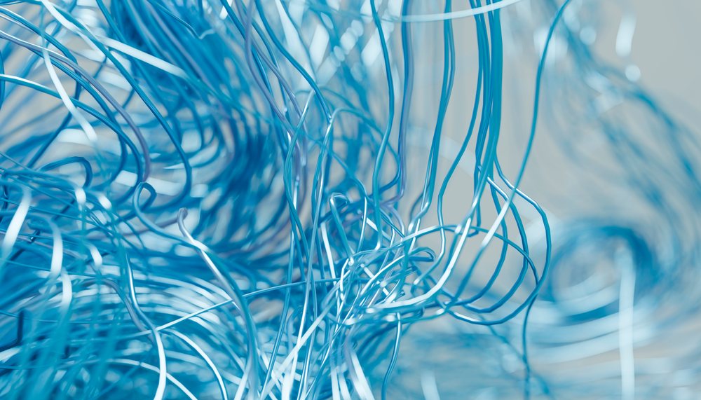 Close-up of tangled blue metal wires twisted and curled in an abstract pattern.