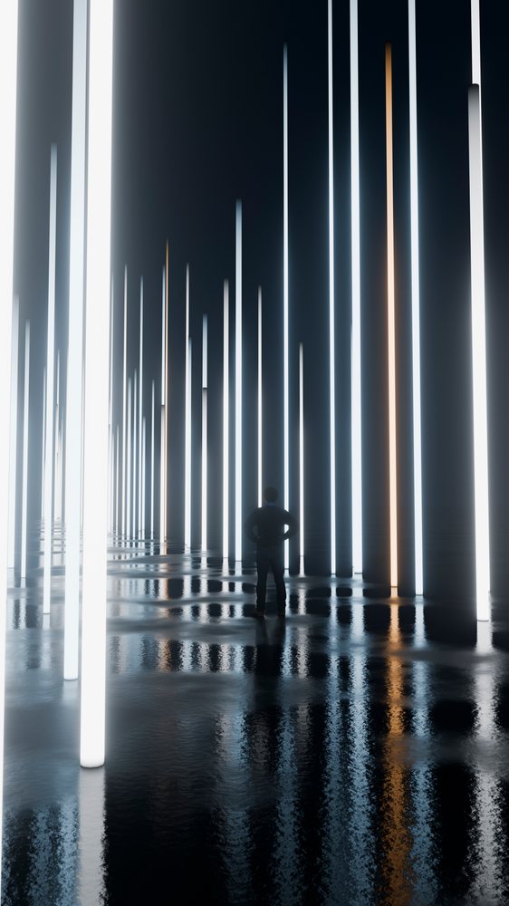 Man stands silhouetted amid vertical glowing light pillars reflecting on a wet floor in a dark modern art installation.