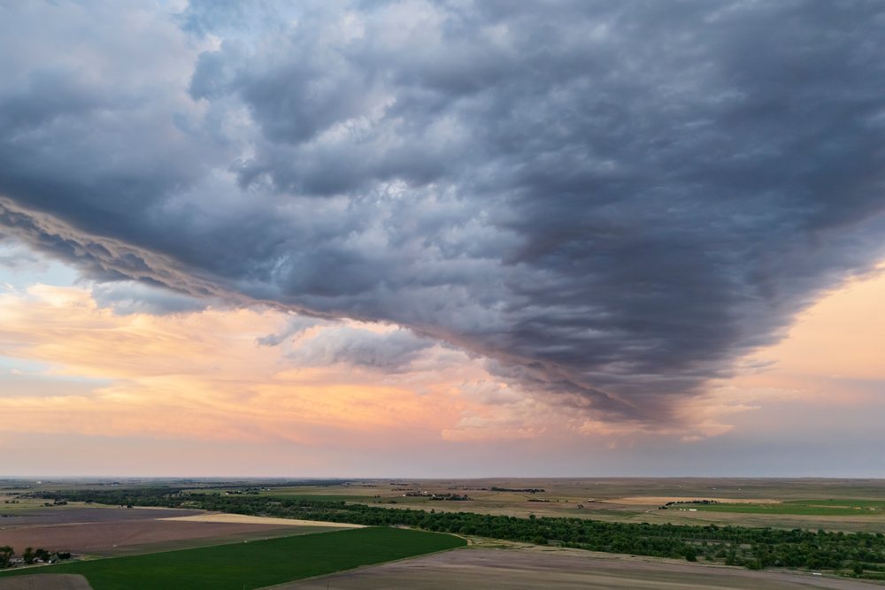 Storm clouds gather over Great Plains farmland at sunset during Storm Chasing, Weather, Environmental, Sterling, Colorado, USA.