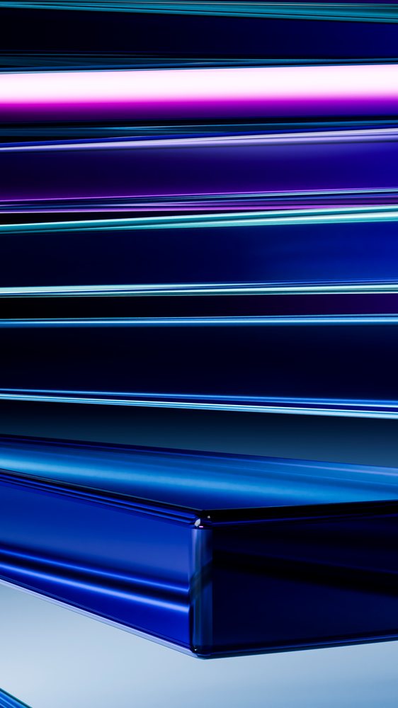 Stacked blue glass blocks with reflective surfaces create an abstract modern design with glossy, transparent layers.