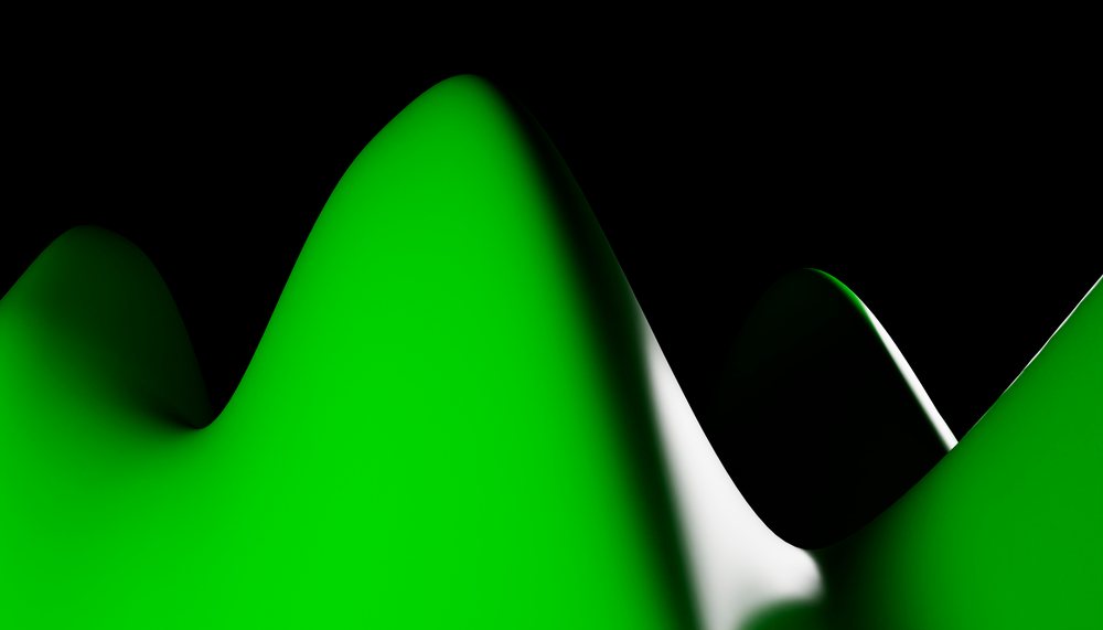 Close-up of smooth green wave-shaped abstract forms against a black background.
