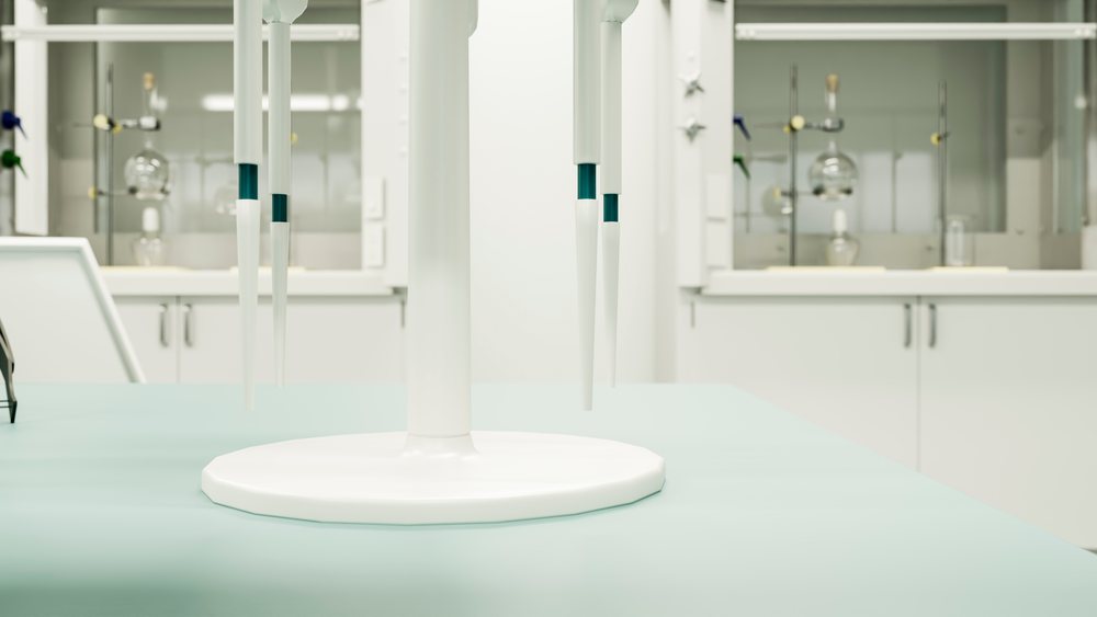 Laboratory pipettes with plastic tips positioned on a stand on a bench in a clean scientific research lab environment.