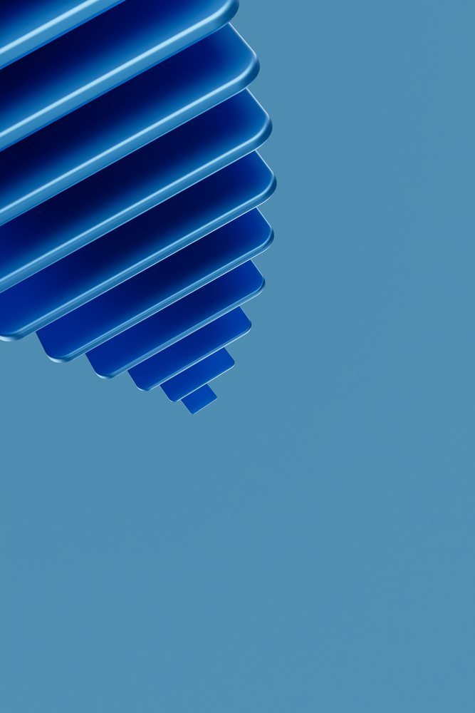 Abstract blue 3D stacked layers forming a geometric shape on a blue background.