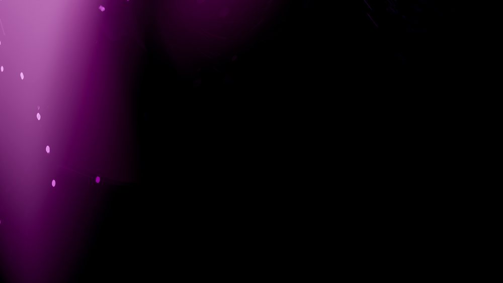 Abstract digital art featuring glowing purple lights and light bokeh on a dark background creating a vibrant, futuristic scene.